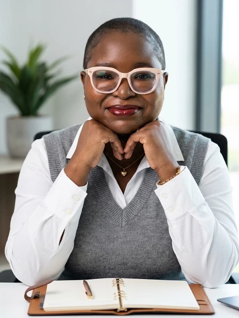 Jane, founder of OnyiWrites, seated at her desk with an open planner